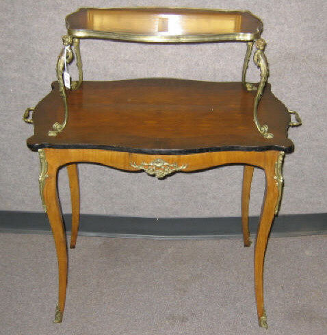 Appraisal: FRENCH TWO-TIERED MARQUETRY CENTER TABLE Shaped and crossbanded gilt bound