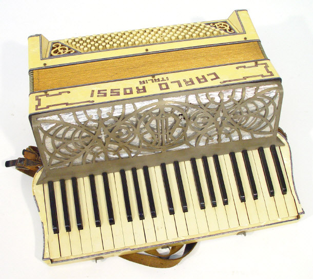 Appraisal: Italian Carlo Rossi accordian with yellow and blue marblised case