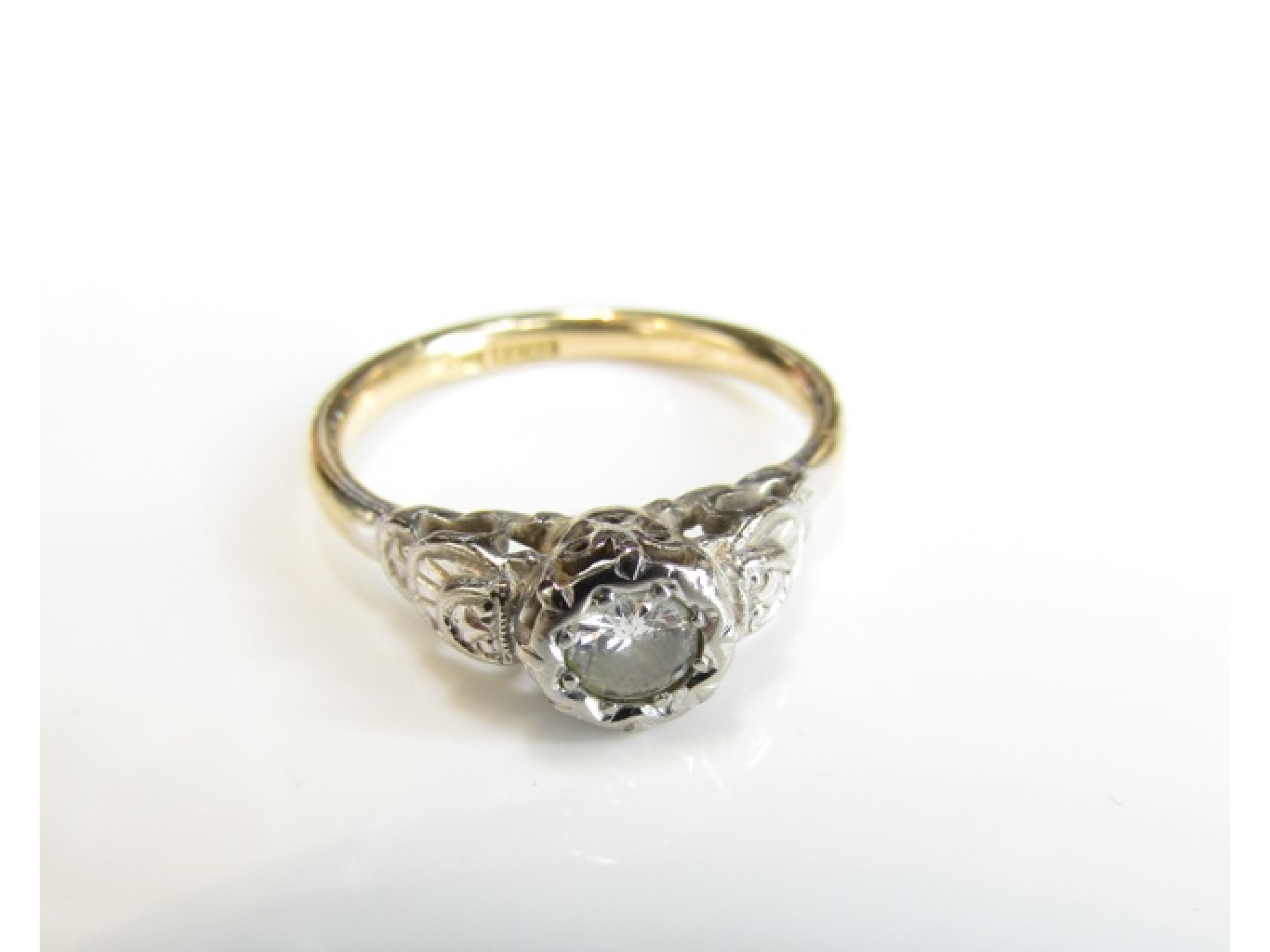 Appraisal: A diamond ring set with a round brilliant-cut diamond weighing