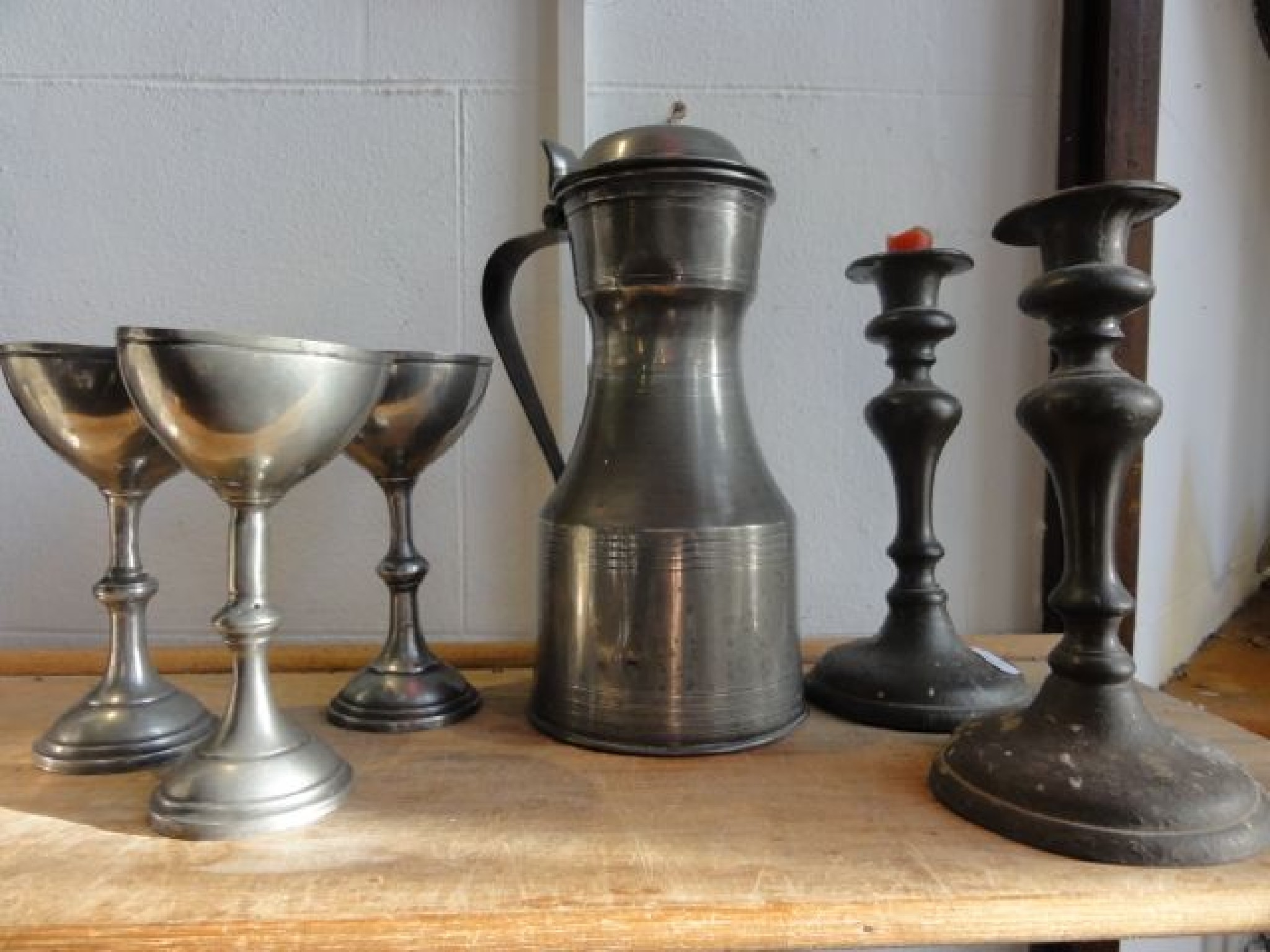 Appraisal: A pair of antique pewter candlesticks with bulbous shaped stemmed