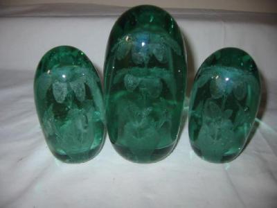 Appraisal: A SET OF THREE GREEN GLASS DUMPS of slender tapering