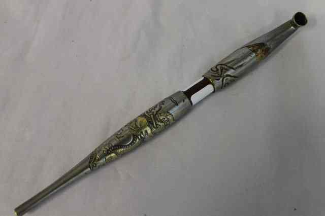 Appraisal: A JAPANESE SILVER METAL TOBACCO PIPE with carved dragon decoration