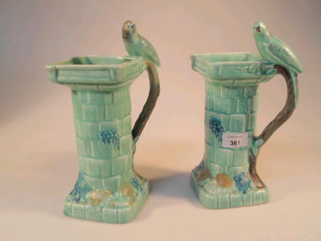 Appraisal: A pair of Flaxmen ware pottery vases modelled as bird