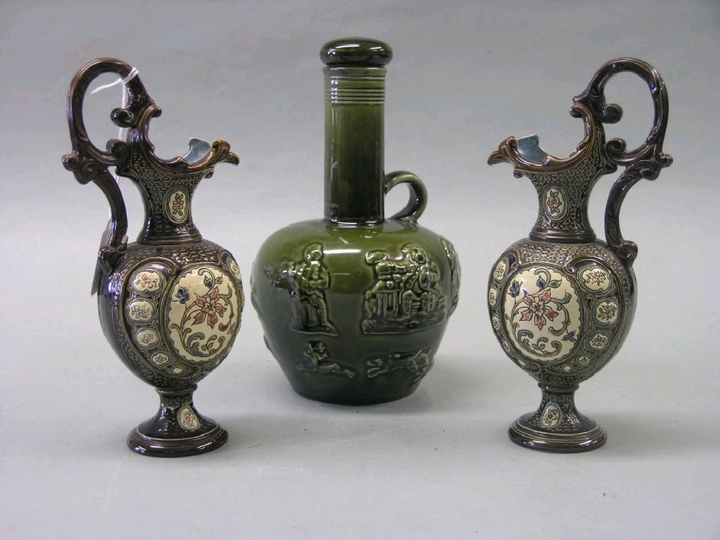 Appraisal: A pair of German majolica ewers with double-scroll handles in