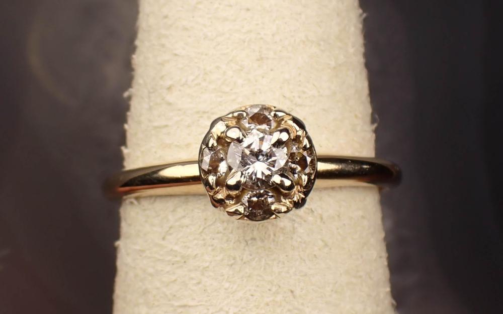 Appraisal: DIAMOND AND FOURTEEN KARAT TWO-TONE GOLD RING The yellow and