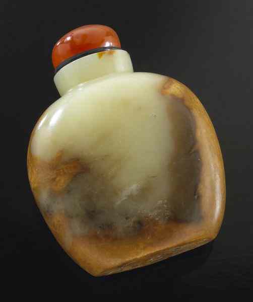 Appraisal: Chinese Qing carved jade snuff bottlewith russet skin and an