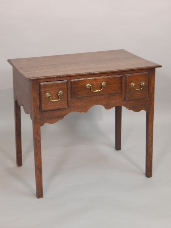 Appraisal: An early thC oak lowboy with three frieze drawers above