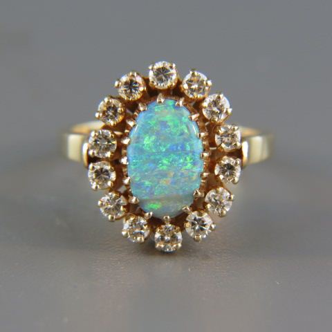 Appraisal: Black Opal Diamond Ring oval cabachon fiery gem weighing carats