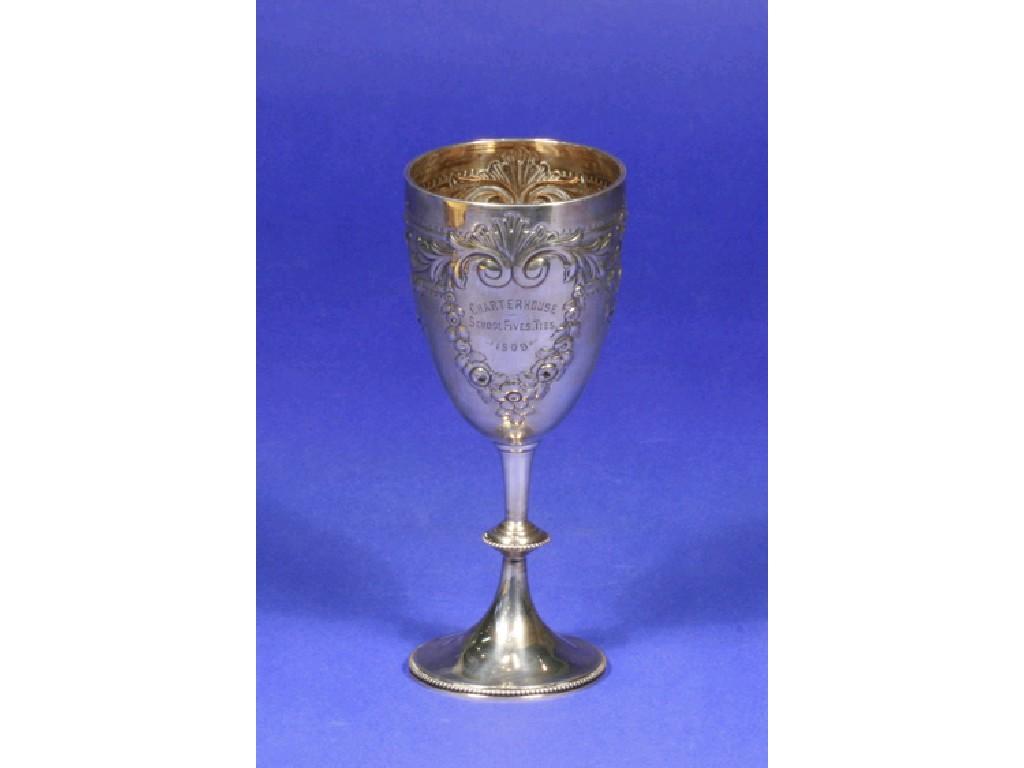 Appraisal: AN EDWARDIAN PRESENTATION GOBLET embossed with flowers and scrolls and