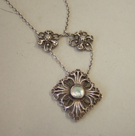 Appraisal: A silver and blister pearl pendant necklace in a quatrefoil