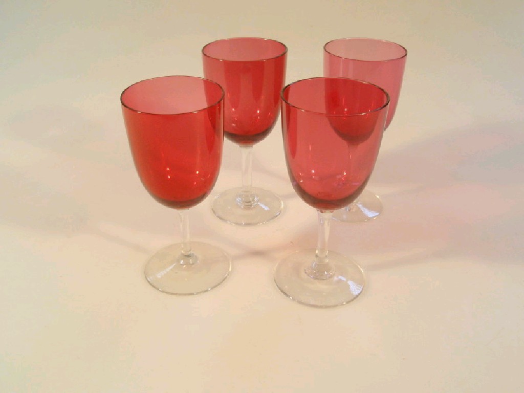 Appraisal: Four Victorian cranberry wine glasses with clear stems