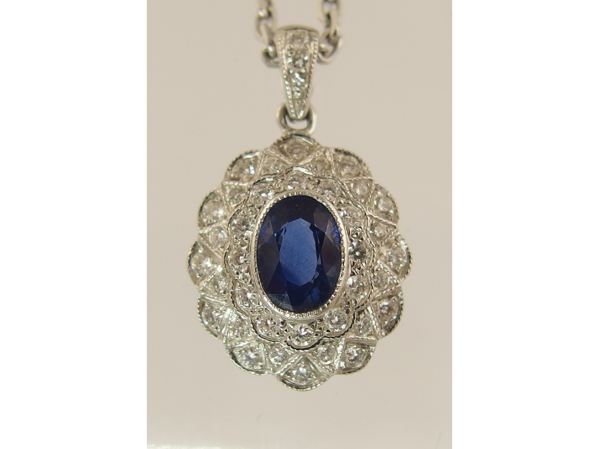 Appraisal: An ct white gold sapphire and diamond pendantset with an