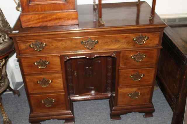 Appraisal: A GEORGE III MAHOGANY KNEEHOLE DESK having a rectangular top