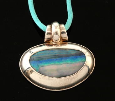 Appraisal: An opal and silver pendant The free form boulder opal