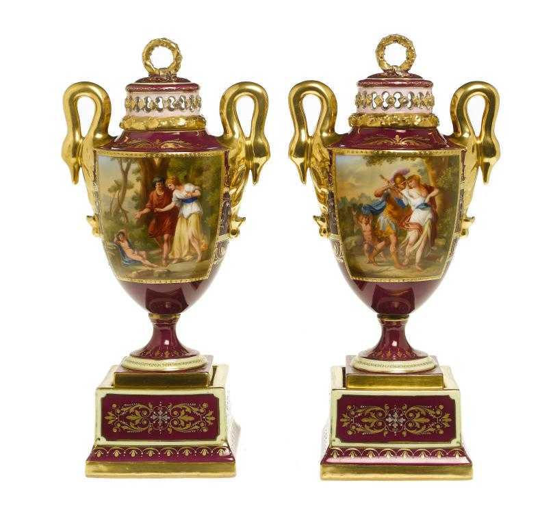 Appraisal: A PAIR OF VIENNA STYLE CLARET GROUND VASES AND COVERS