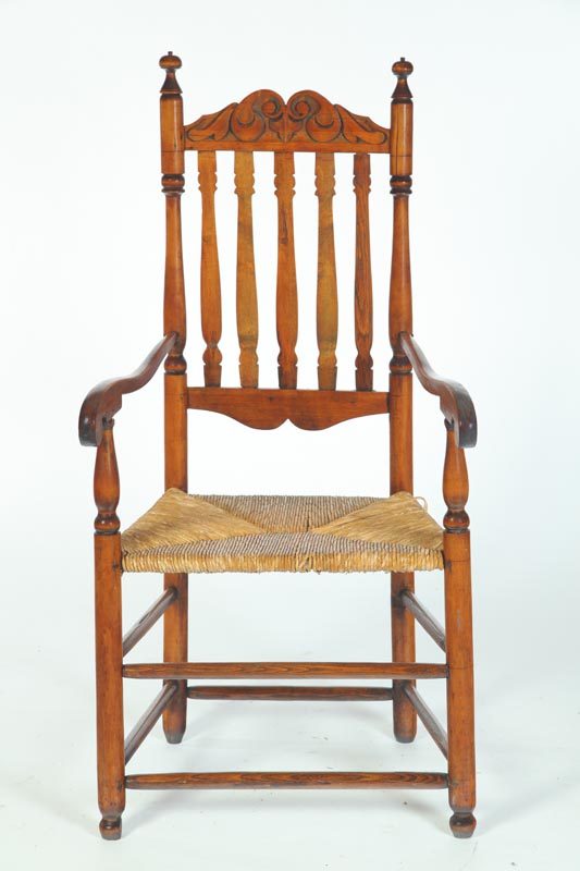 Appraisal: BANNISTER BACK ARMCHAIR American th century hardwood Carved crest Added