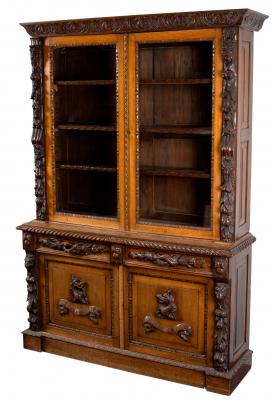 Appraisal: A carved oak bookcase with maskhead fruit and foliate pillars