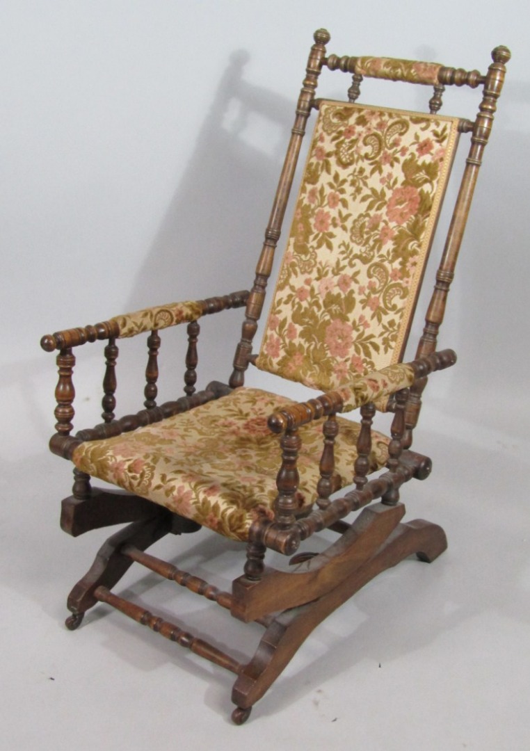 Appraisal: A late thC oak framed American rocking chair with overstuffed