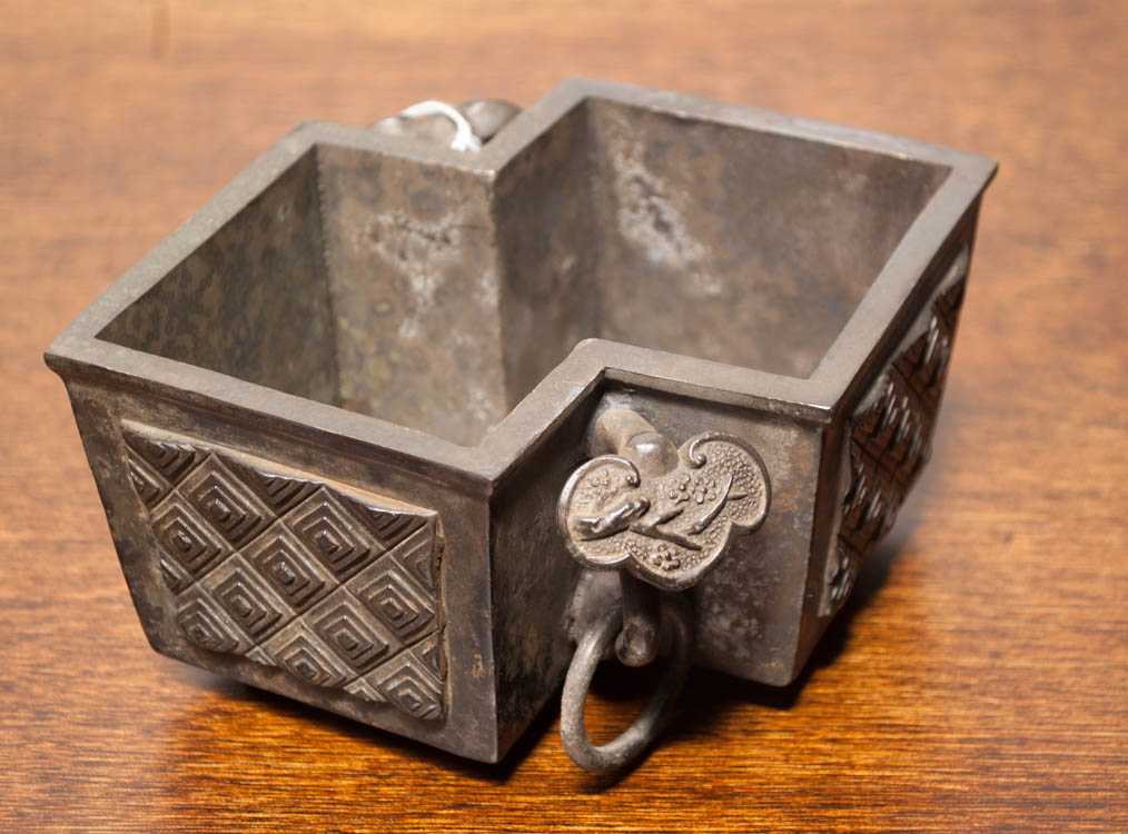 Appraisal: CHINESE QING BRONZE CENSOR in angular form adorned with raised