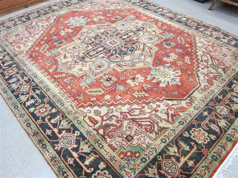 Appraisal: HAND KNOTTED ORIENTAL CARPET Persian Serapi design central geometric medallion