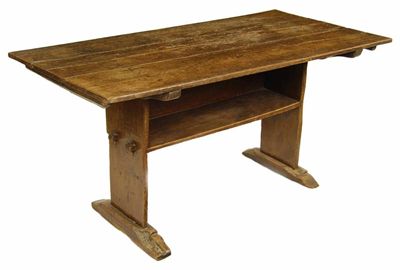 Appraisal: An oak bench table with a pivoted hinged triple boarded