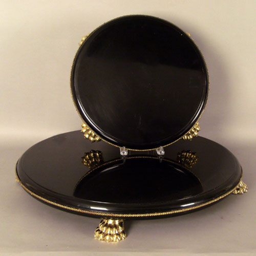 Appraisal: Two ebonized trays with gilt metal mounts h x dia