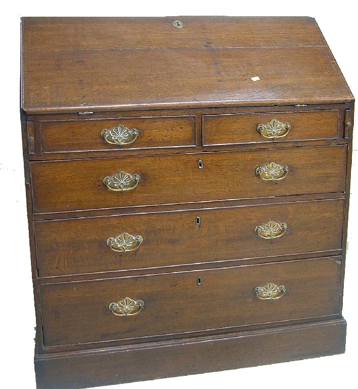 Appraisal: George III oak bureau the fall front enclosing a fitted