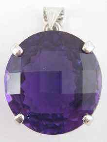 Appraisal: A faceted amethyst pendant set in white metal the amethyst