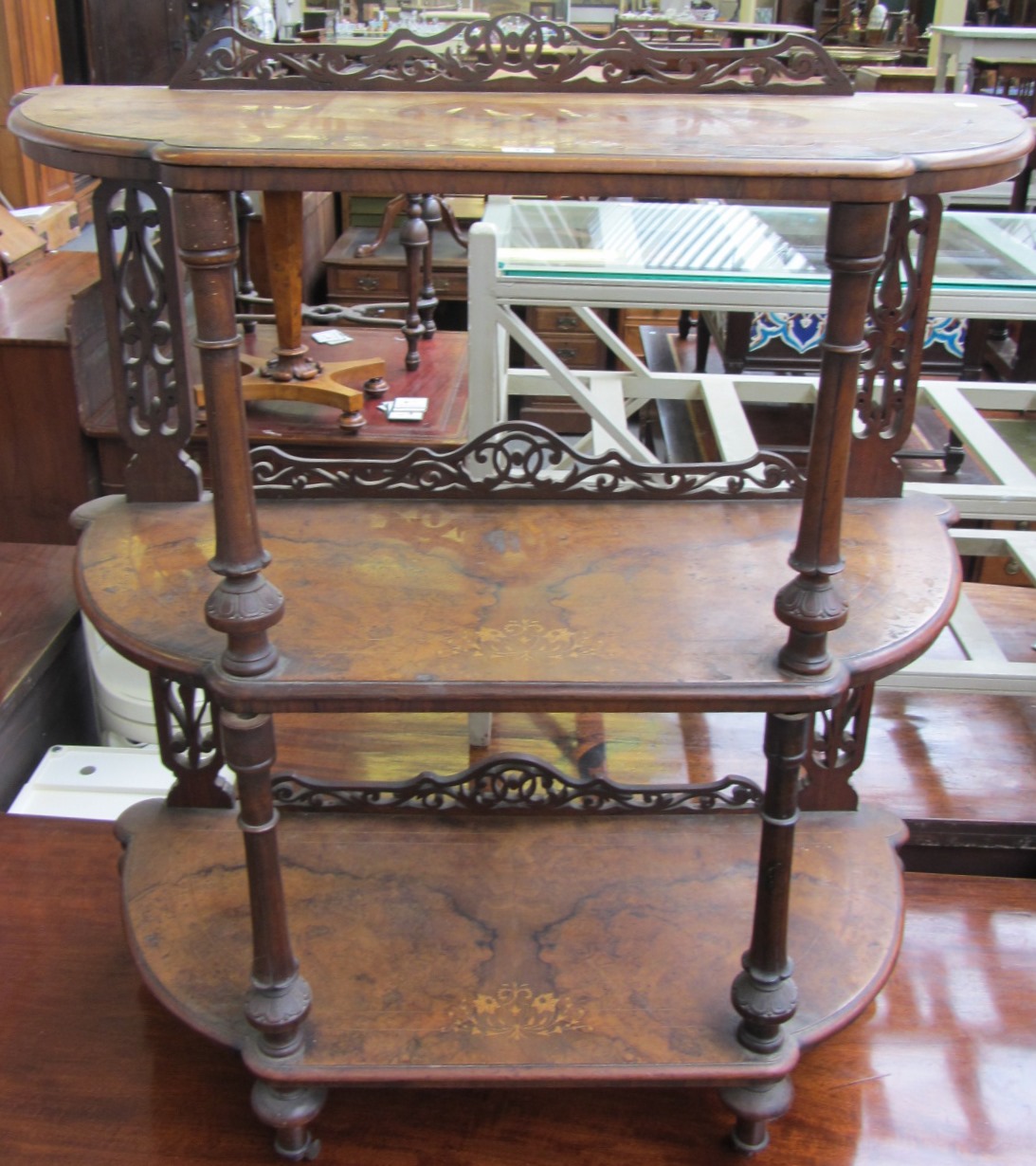 Appraisal: A Victorian marquetry inlaid figured walnut bowfront three tier what-not