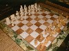 Appraisal: A green onyx chess board inset with golden and white