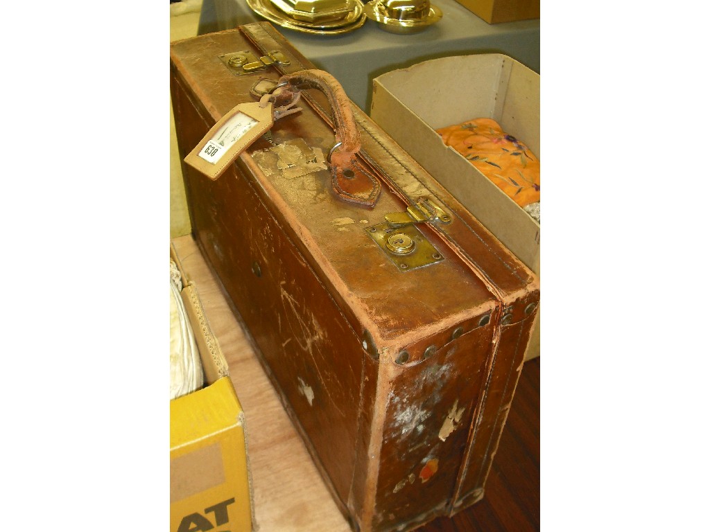 Appraisal: Tan leather suitcase containing a quantity of embroidered and crochet