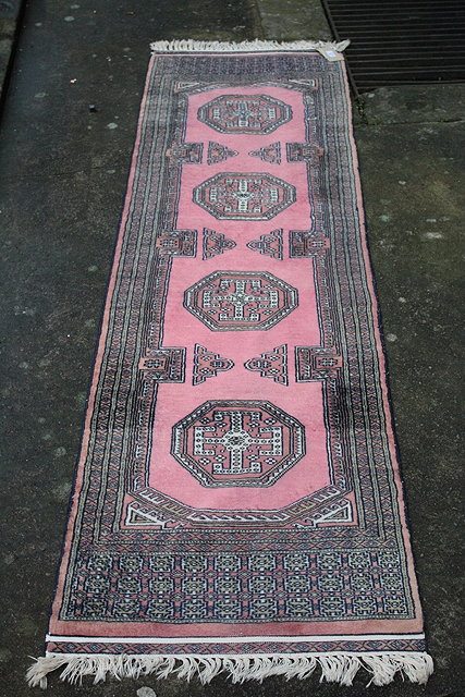 Appraisal: A SMALL PAKISTAN PINK GROUND RUNNER with four medallions cm