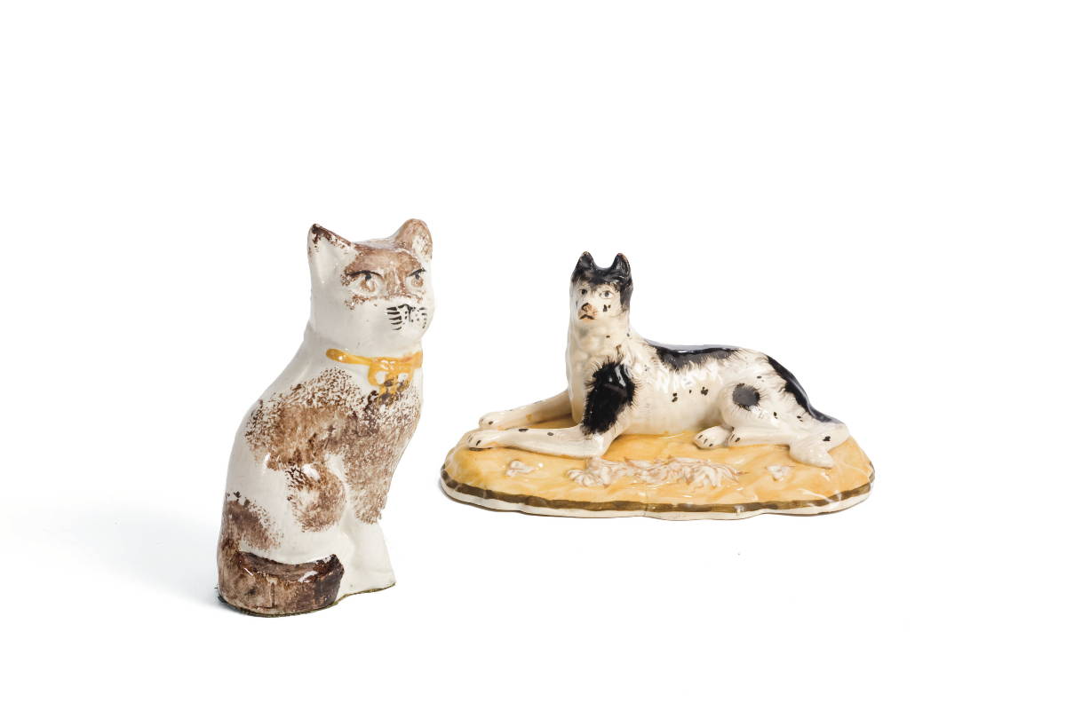 Appraisal: STAFFORDSHIRE POTTERY SPONGE-DECORATED MODEL OF A SEATED CAT AND AN