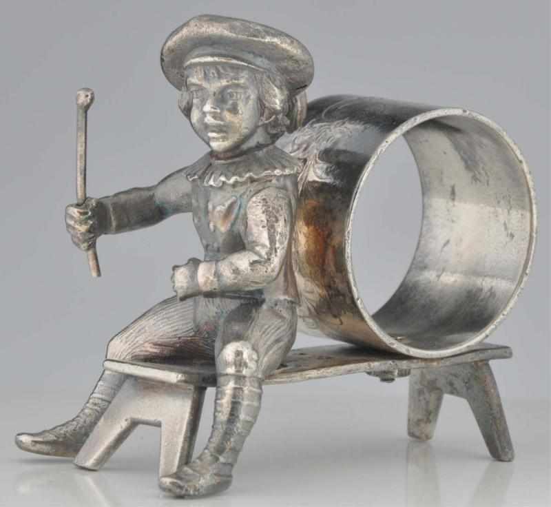 Appraisal: Kate Greenaway Figural Napkin Ring Boy with stick sits on