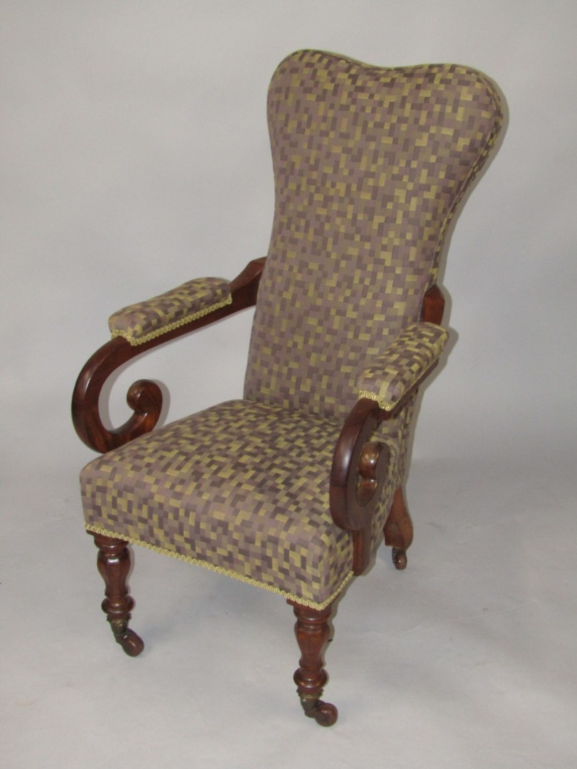 Appraisal: A Victorian mahogany open armchair with a shaped padded back