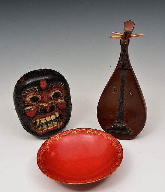 Appraisal: Two Japanese okimono and a red lacquer sake cup th