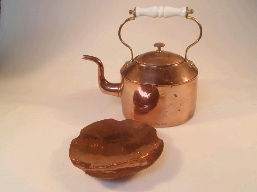 Appraisal: An oval copper kettle with a white ceramic and brass