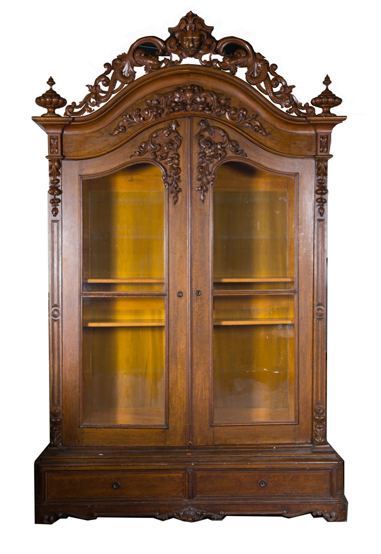 Appraisal: a Rococo Revival carved oak bookcase circa arched foliated scroll