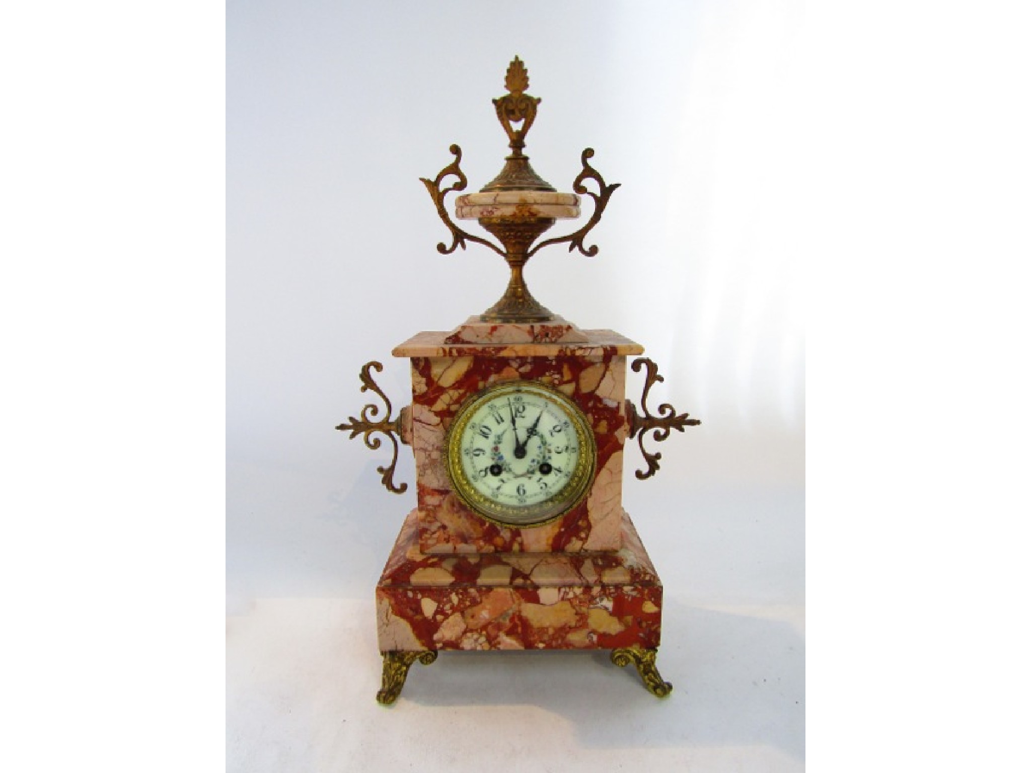 Appraisal: A mid Victorian polished marble mantel clock with applied brass