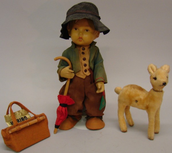 Appraisal: Lot Rubber Hummel boy The Happy Wanderer doll Green wooden