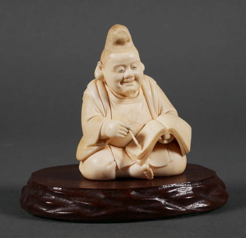 Appraisal: Japanese carved ivory scholar figure writing in book Figurine measures