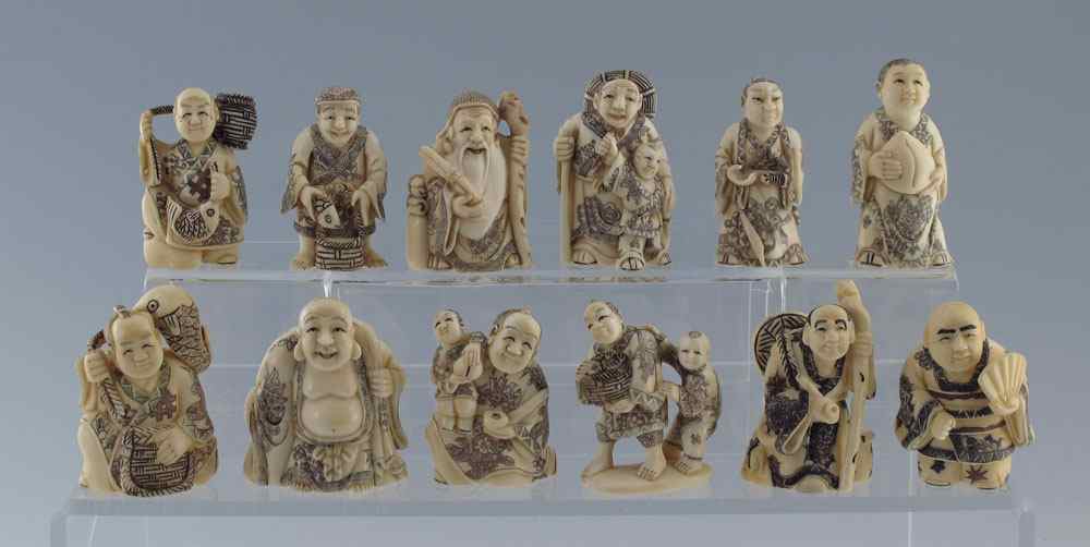 Appraisal: CARVED IVORY NETSUKE IN PRESENTATION BOX An assortment of figures