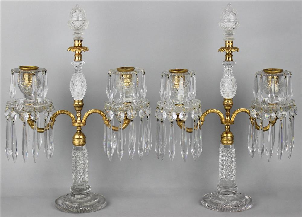 Appraisal: PAIR OF REGENCY GILT METAL AND CUT GLASS TWO-LIGHT CANDELABRA