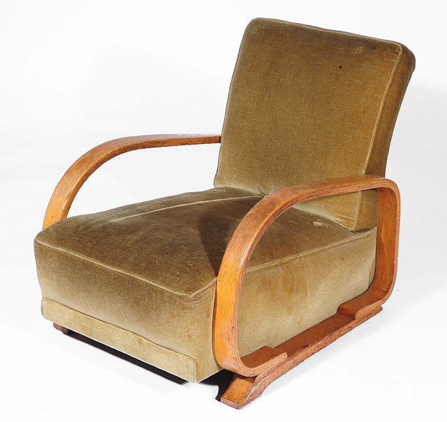 Appraisal: A Heals oak armchaircirca with fixed upholstered seat and back