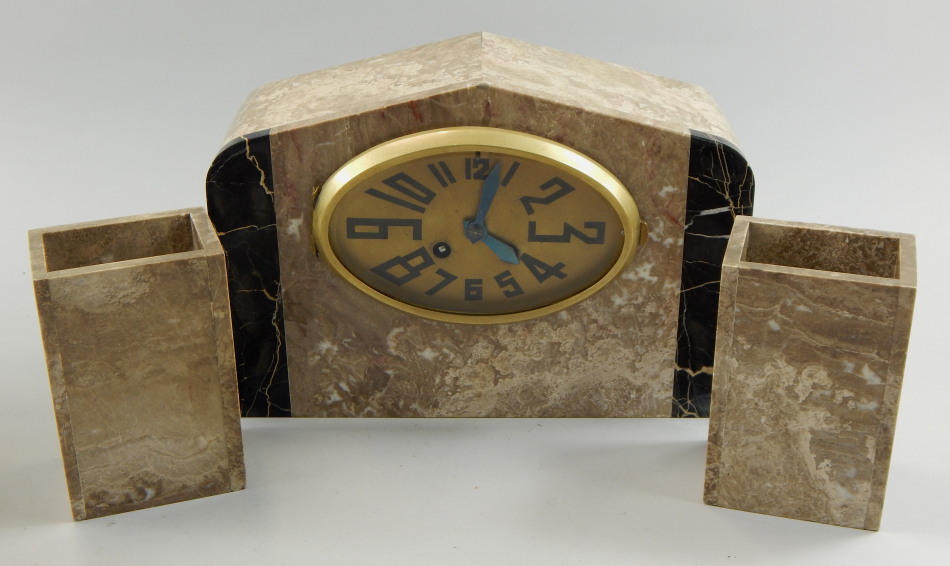 Appraisal: A French Art Deco clock garniture with oval dial in