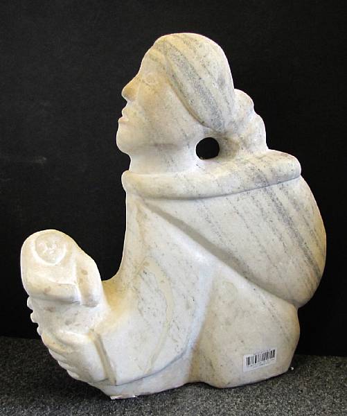 Appraisal: An Inuit stone carving of a mother and child Attached