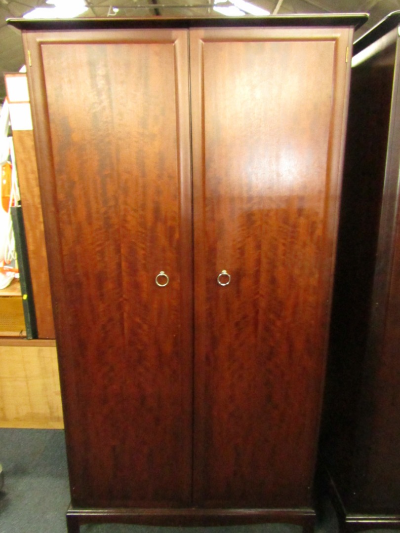 Appraisal: A Stag mahogany two door wardrobe raised on bracket feet