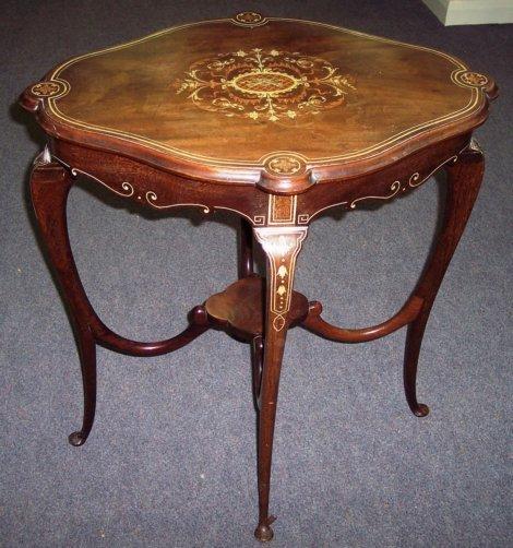 Appraisal: An Edwardian inlaid occasional table on cabriole legs united by