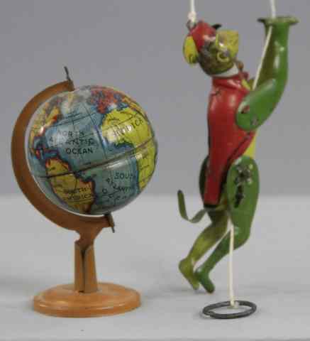 Appraisal: CLIMBING MONKEY AND GLOBE PENNY TOYS Both done in lithographed