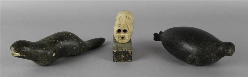 Appraisal: THREE INUIT CARVINGS two stone animals a seal and an